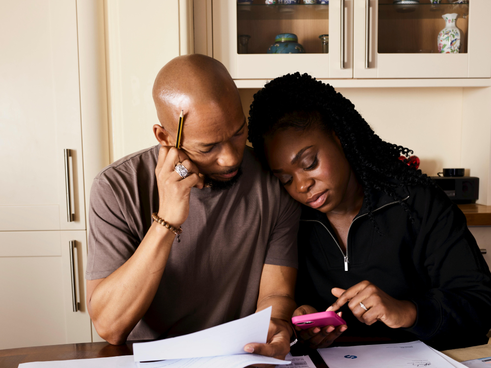 A Canadian man seated in his kitchen, wondering if he's over paying on his utilities bills, including heat, hydro, water and electricity.